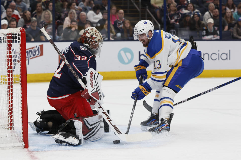 Columbus Blue Jackets' Jon Gillies, left, makes a save against Buffalo Sabres' Lukas Rousek during the first period of an NHL hockey game Friday, April 14, 2023, in Columbus, Ohio. (AP Photo/Jay LaPrete)