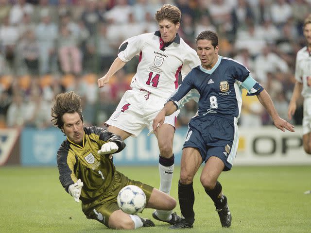 <p>Doug Pensinger/Allsport/Getty</p> Diego Simeone falls under the challenge of David Seaman to win a penalty during the 1998 FIFA World Cup.