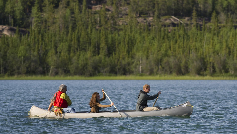 Britain's Prince William (R) and his wife Catherine, Duchess of Cambridge (C), paddle a canoe with Fort Smith's village elder Francois Paulette while visiting Blatchford Lake, Northwest Territories July 5, 2011. Prince William and his wife Catherine are on a royal tour of Canada from June 30 to July 8. REUTERS/Andy Clark    (CANADA - Tags: ENTERTAINMENT SPORT CANOEING POLITICS ROYALS IMAGES OF THE DAY)