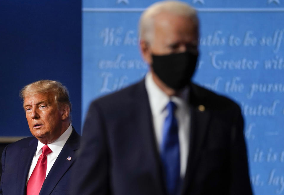 FILE - President Donald Trump, left, remains on stage as then-Democratic presidential candidate former Vice President Joe Biden, right, walks away Thursday, Oct. 22, 2020, at Belmont University in Nashville, Tenn. (AP Photo/Julio Cortez, File)