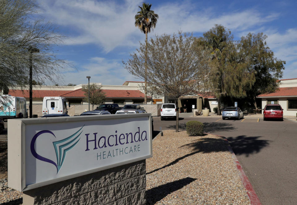 FILE - This Jan. 25, 2019, file photo, shows the Hacienda HealthCare facility in Phoenix. A legal claim against the state of Arizona by the parents of an incapacitated woman who was raped and later gave birth at Hacienda HealthCare alleges the facility and state broke promises to have only female caregivers tend to their daughter. The Arizona Health Care Cost Containment System declined to comment on the claim. (AP Photo/Matt York, File)