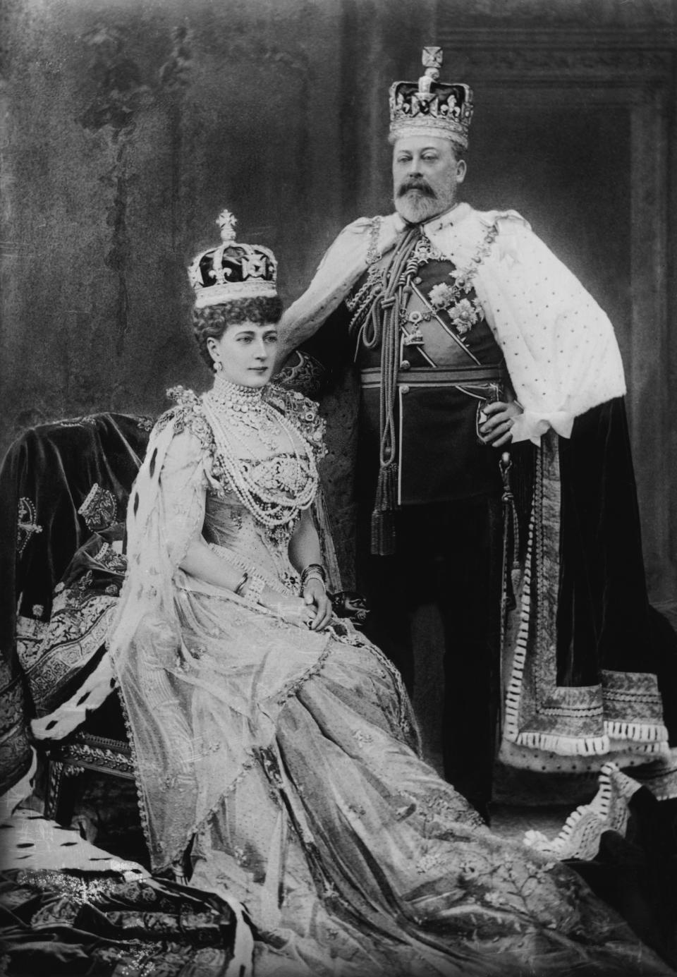 King Edward VII and Queen Alexandra pose in royal attire with crowns and elaborate robes, showcasing regal elegance in a formal portrait