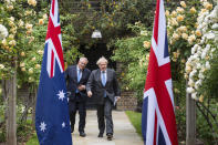 Britain's Prime Minister Boris Johnson, right, walks with Australian Prime Minister Scott Morrison after their meeting, in the garden of 10 Downing Streeet, in London, Tuesday June 15, 2021. Britain and Australia have agreed on a free trade deal that will be released later Tuesday, Australian Trade Minister Dan Tehan said. (Dominic Lipinski/Pool Photo via AP)