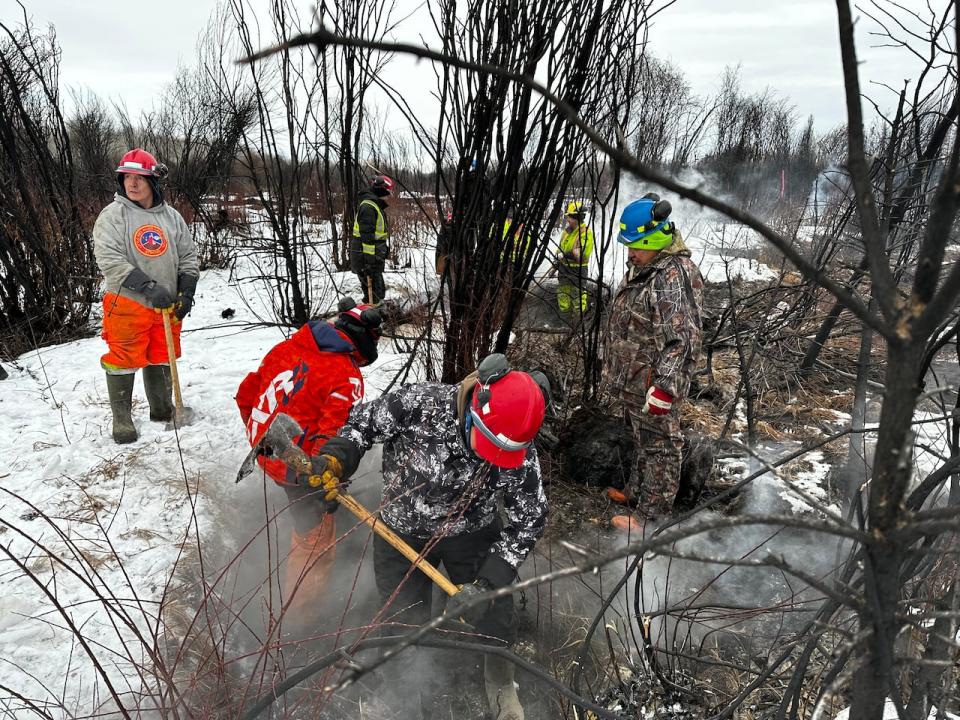 Firefighters work on the Paskwa Wildfire, near Fox Lake, Alta. in February 2024.