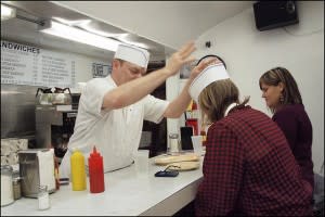 Short order cook giving someone a hat