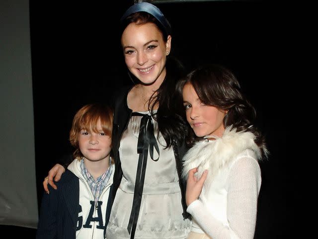 <p>Bryan Bedder/Getty</p> Lindsay Lohan with her brother Dakota and sister Aliana backstage at the Child Magazine Fall 2006 fashion show on February 6, 2006 in New York City