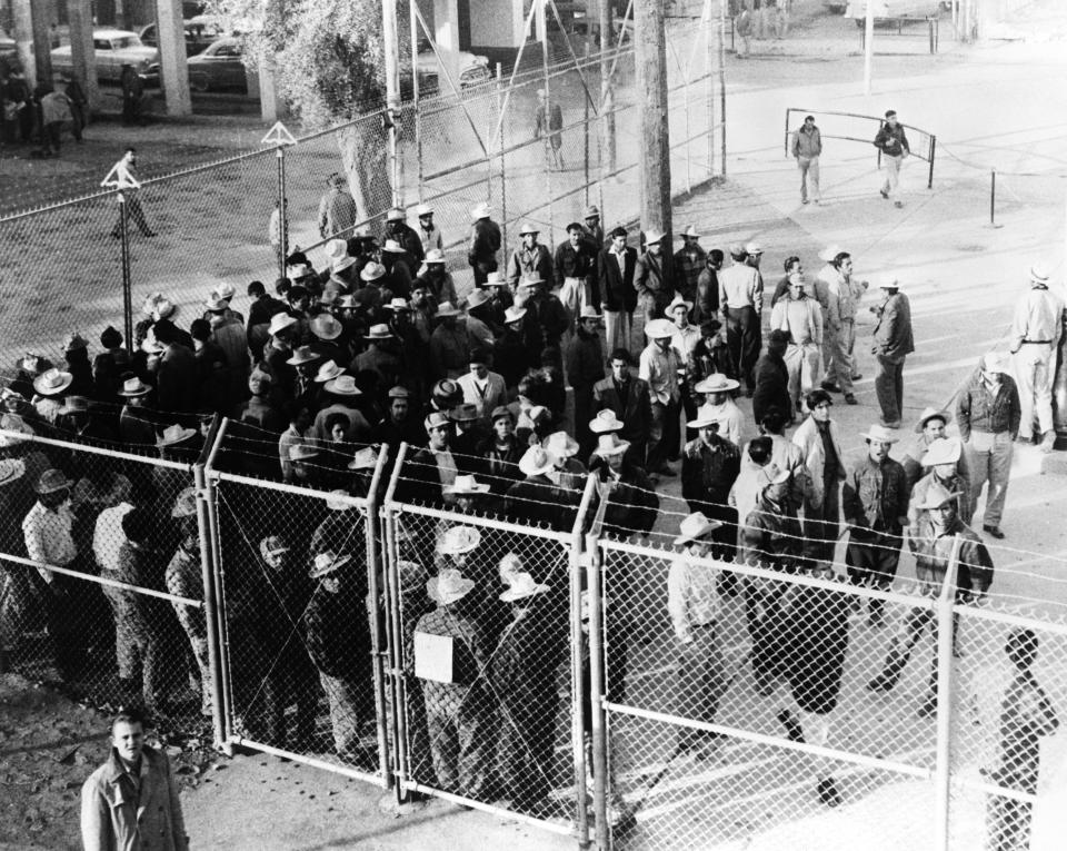 Mexican workers waiting just inside the U.S. border to be let in.