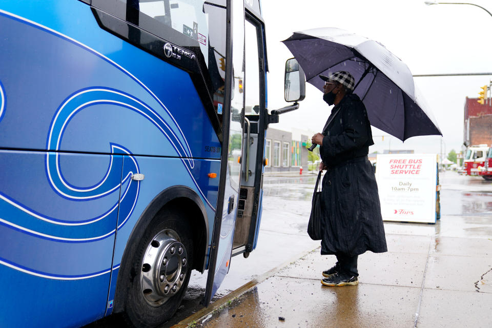 A person inquires about a free shuttle bus transporting residents whose local supermarket has been closed in the aftermath of a shooting, to another store, in Buffalo, N.Y., Monday, May 16, 2022. (AP Photo/Matt Rourke)