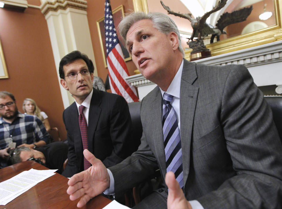 FILE - Then-House Majority Whip Kevin McCarthy of Calif., right, joined by House Majority Leader Eric Cantor of Va., speaks to reporters about President Obama's debt reduction plan and other issues, on Capitol Hill in Washington, on Sept. 20, 2013. Lessons learned from the debt ceiling standoff more than a decade ago are rippling through Washington. Back in 2011 the debate around raising the debt ceiling was eerily familiar. Newly elected House Republicans were eager to confront the Democratic president and force spending cuts. (AP Photo/J. Scott Applewhite, File)