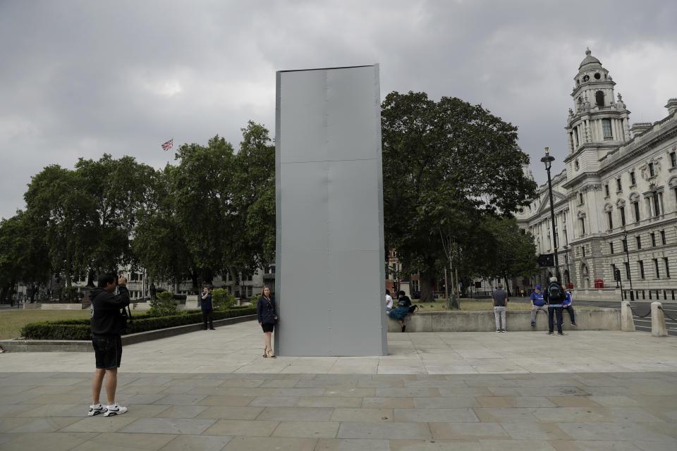 A protective screen put up late Thursday encloses the statue of Britain's World War II Prime Minister Winston Churchill ahead of expected rival demonstrations by anti-racism and far-right protesters in London, Friday, June 12, 2020. Last Sunday the statue was daubed with the words "was a racist" during a protest against racism and police violence after the May 25 death of George Floyd, a black man who died after a white Minneapolis US police officer pressed a knee to his neck. (AP Photo/Matt Dunham)