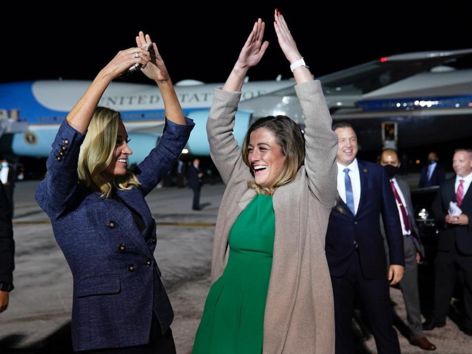 White House press secretary Kayleigh McEnany and White House legislative aide Cassidy Hutchinson dance to the song YMCA as President Donald Trump ends a campaign rally at Eugene F. Kranz Toledo Express Airport, Monday, Sept. 21, 2020.
