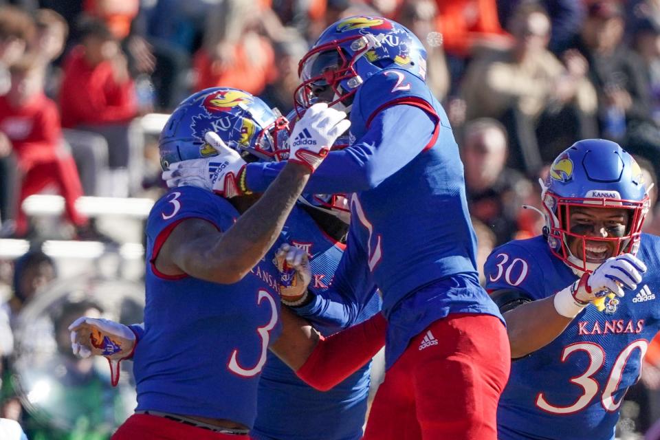 Kansas Jayhawks cornerback Ra'Mello Dotson (3) celebrates with cornerback Cobee Bryant (2) against the Oklahoma State Cowboys after an interception during the first half of the game at David Booth Kansas Memorial Stadium.