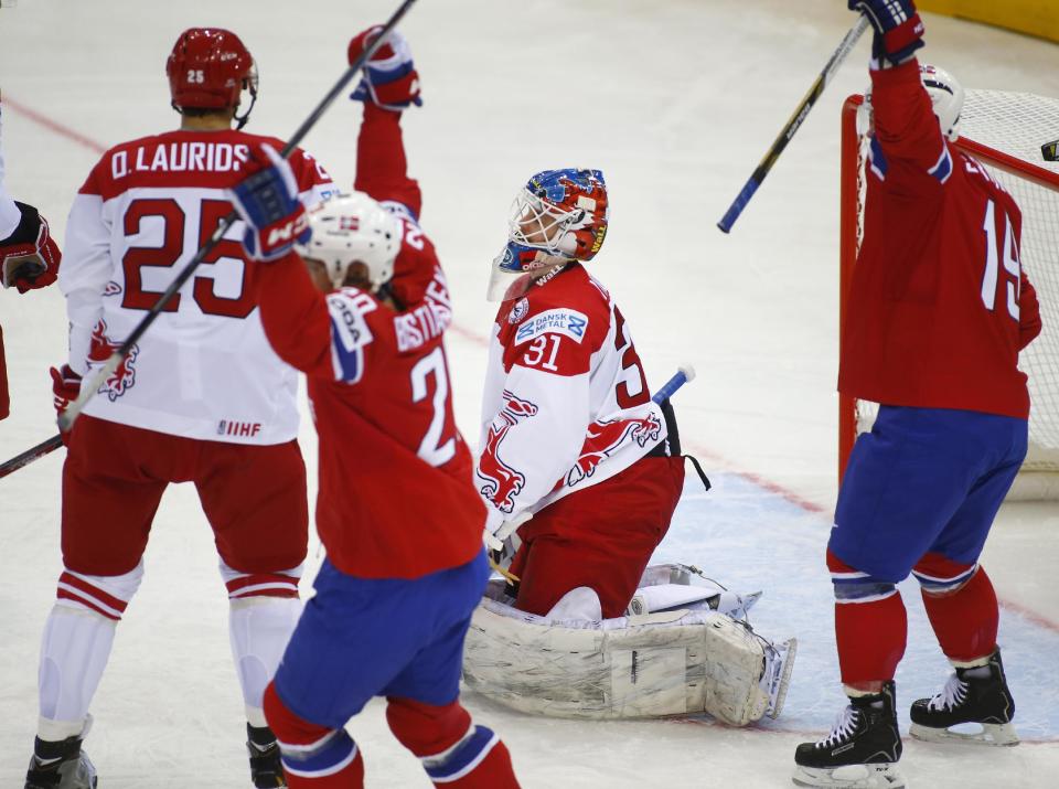 Denmark's goalie Simon Nielsen, center, reacts after Norway's Jonas Holos scored during the Group A preliminary round match at the Ice Hockey World Championship in Minsk, Belarus, Sunday, May 11, 2014. (AP Photo/Sergei Grits)