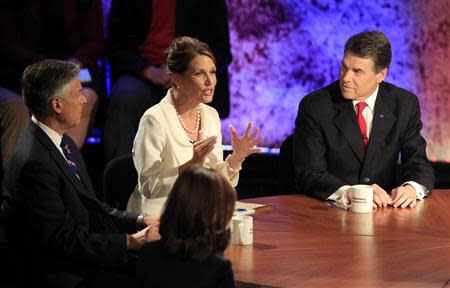 Republican presidential hopefuls (L-R) former Utah Governor Jon Huntsman, U.S. Rep. Michele Bachmann (R-MN), and Texas Gov. Rick Perry participate in a Republican presidential debate at Dartmouth College in Hanover, New Hampshire October 11, 2011. REUTERS/Adam Hunger