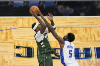 Milwaukee Bucks center Bobby Portis, left, attempts a shot over Orlando Magic center Mo Bamba (5) during the second half of an NBA basketball game, Sunday, April 11, 2021, in Orlando, Fla. (AP Photo/John Raoux)