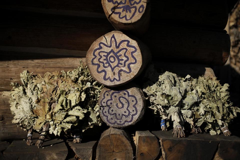 Dried herbs sit in the sun outside a steam sauna at the British Banya bathhouse, Saturday, Feb. 15, 2014, in Krasnaya Polyana, Russia, just a few miles away from the ski slopes where athletes are competing for Olympic medals. (AP Photo/Jae C. Hong)