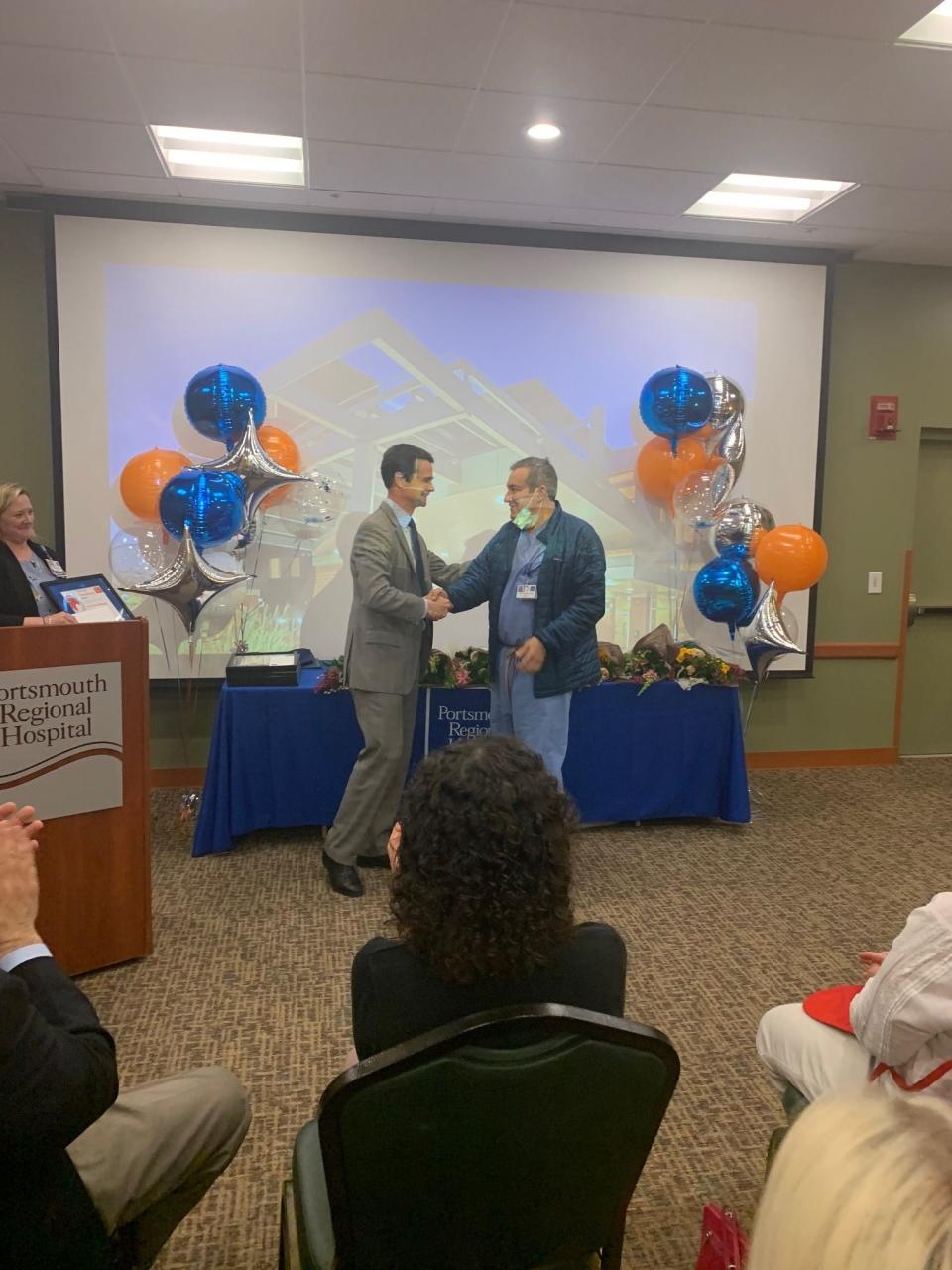 Archie McGowan, MD, right, accepts the 2021 Frist Humanitarian Award – Physician from Portsmouth Regional Hospital CEO, Dean M. Carucci.