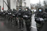 Riot police block an area to protect against demonstrators gathered for an anti-vaccination protest in Kyiv, Ukraine, Wednesday, Nov. 3, 2021. In a bid to stem contagion, Ukrainian authorities have required teachers, government employees and other workers to get fully vaccinated by Nov. 8 or face having their salary payments suspended. In addition, proof of vaccination or a negative test is now required to board planes, trains and long-distance buses. (AP Photo/Efrem Lukatsky)