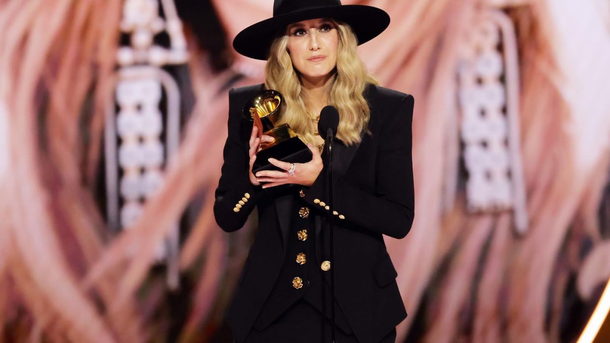 lainey wilson holding her grammy trophy after winning best country album