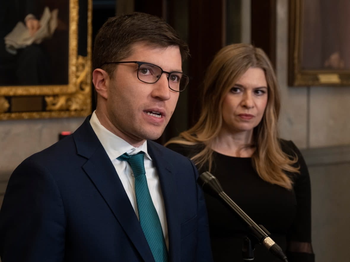 Conservative Treasury Board critic Stephanie Kusie looks on as Conservative international development critic Garnett Genuis speaks with media in the foyer of the House of Commons on February 6, 2023 in Ottawa. (Adrian Wyld/Canadian Press - image credit)