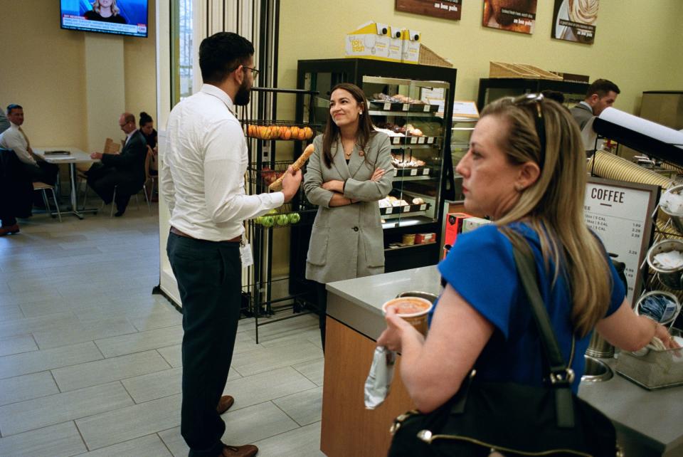 AOC talks with an intern from her office in Au Bon Pain while grabbing lunch. People recognize her nearly everywhere.