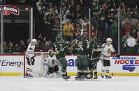 Minnesota Wild right wing Ryan Reaves (75) celebrates with teammates after scoring a goal against the Chicago Blackhawks during the second period of an NHL hockey game Saturday, March 25, 2023, in St. Paul, Minn. (AP Photo/Stacy Bengs)