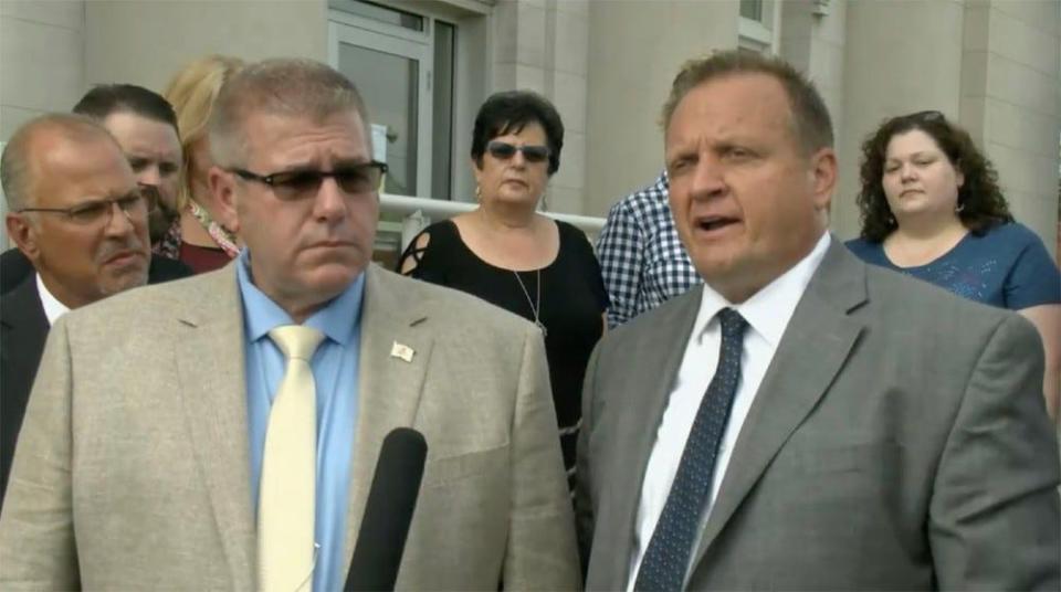 Rep. Darren Bailey (left), R-Xenia, and his attorney, Thomas DeVore, speak to reporters Thursday outside the Clay County Courthouse in Louisville after a judge there ruled that all of Gov. JB Pritzker’s executive orders since April 8 pertaining to the novel coronavirus pandemic are void because he exceeded his authority when he used his emergency powers for more than 30 days. (Credit: blueroomstream.com)