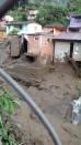 Damaged homes and a street covered in mud and debris are seen in the municipality of Salgar, in Antioquia department after a landslide in this May 18, 2015 handout image provided by Colombian Air Force. A landslide sent mud and water crashing onto homes in a town in Colombia's northwest mountains on Monday, killing at least 48 people and injuring dozens, officials said. Heavy rains caused a ravine to overflow, sending mud and water onto neighboring homes in Salgar. REUTERS/Colombian Air Force/Handout via Reuters ATTENTION EDITORS - THIS PICTURE WAS PROVIDED BY A THIRD PARTY. REUTERS IS UNABLE TO INDEPENDENTLY VERIFY THE AUTHENTICITY, CONTENT, LOCATION OR DATE OF THIS IMAGE. FOR EDITORIAL USE ONLY. NOT FOR SALE FOR MARKETING OR ADVERTISING CAMPAIGNS. THIS PICTURE IS DISTRIBUTED EXACTLY AS RECEIVED BY REUTERS, AS A SERVICE TO CLIENTS.