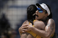 Agatha Bednarczuk, of Brazil, and Eduarda Santos Lisboa, of Brazil, reacts after a point against Argentina during a women's beach volleyball match at the 2020 Summer Olympics, Saturday, July 24, 2021, in Tokyo, Japan. (AP Photo/Felipe Dana)