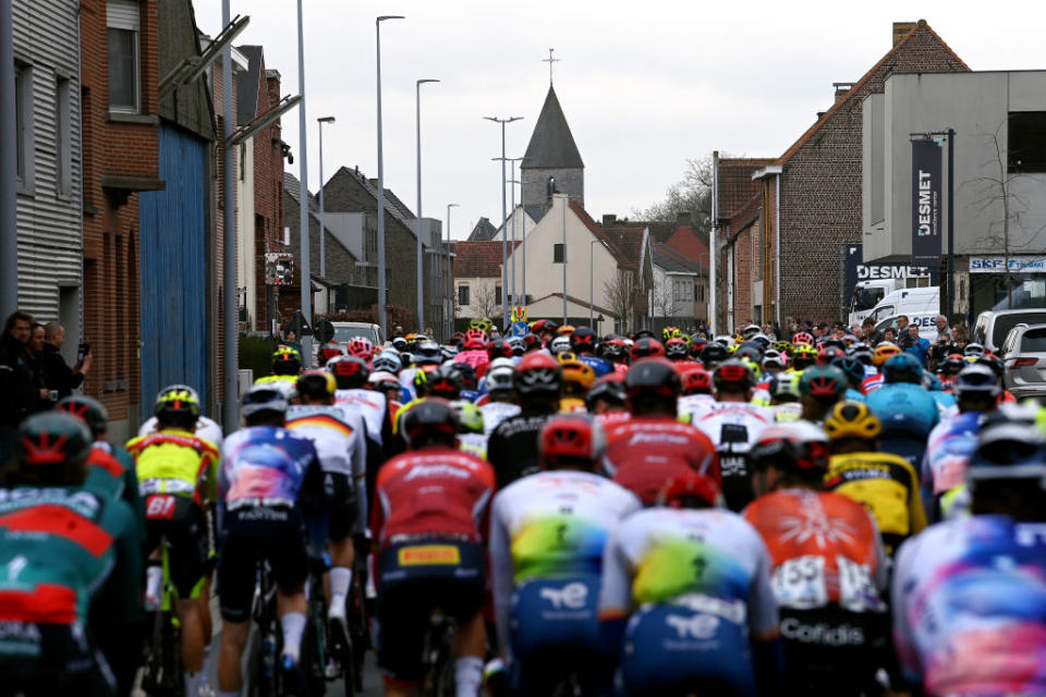 WAREGEM BELGIUM  MARCH 29 A general view of the peloton passing through a Ooigem village during the 77th Dwars Door Vlaanderen 2023  Mens Elite a 1837km one day race from Roeselare to Waregem  DDV23  on March 29 2023 in Waregem Belgium Photo by Tim de WaeleGetty Images