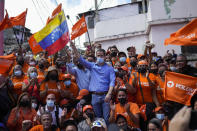 FILE - Venezuela opposition leader Juan Guaido poses for a group photo with residents after presenting his unity plan for Venezuelans, in Maiquetia, Venezuela, Saturday, Feb. 19, 2022. The faction of the Venezuelan opposition backed by the United States says it plans to hold primary contests next year to choose a presidential candidate for the planned 2024 election. (AP Photo/Matias Delacroix, FIle)