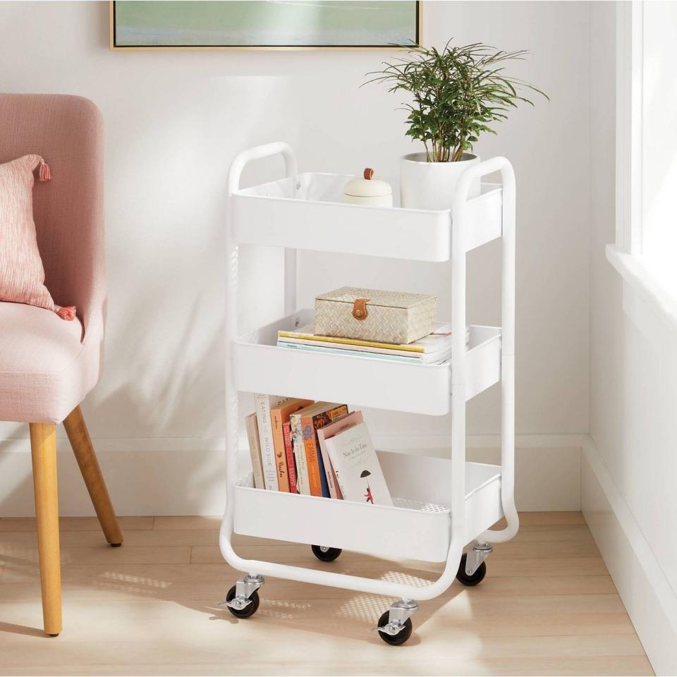 The cart in white with books on it