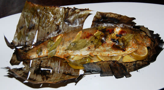 Grilled trout in banana leaf