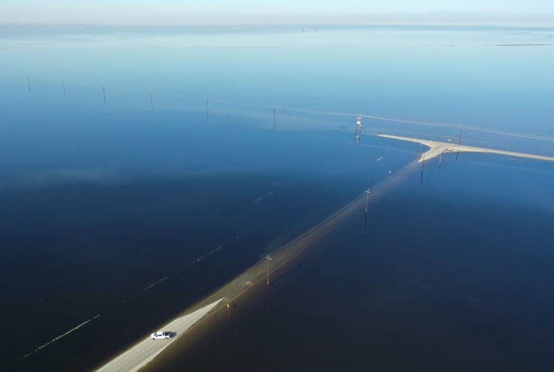 A car turns around after floodwaters become too unmanageable in Tulare Lake near Corcoran, CA on April 27, 2023.