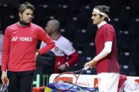 Roger Federer (R) and Stanislas Wawrinka of Switzerland attend a Davis Cup tennis training session at the Pierre Mauroy stadium in Villeneuve d'Ascq, northern France, November 20, 2014. REUTERS/Pascal Rossignol