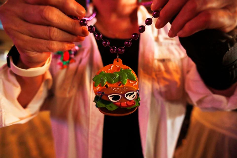 Cyndi Coury, former treasurer of The Parrot Head Club of Memphis can be seen wearing a burger necklace at a get-together to honor Jimmy Buffett at Lafayette's Music Room in Memphis, Tenn., on Sept. 4, 2023.