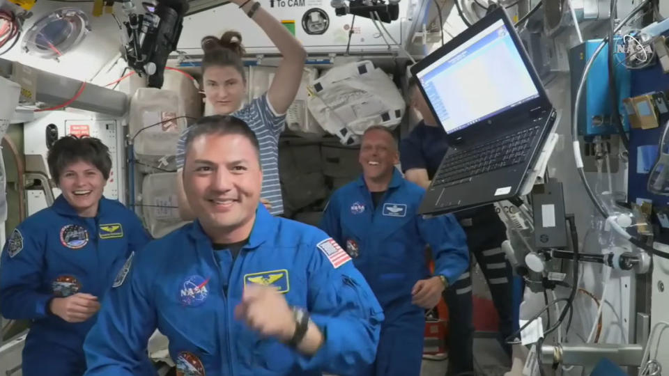 The four astronauts of SpaceX's Crew-4 mission for NASA share warm hugs and big smiles with their Crew-3 counterparts after entering the International Space Station on April 27, 2022.