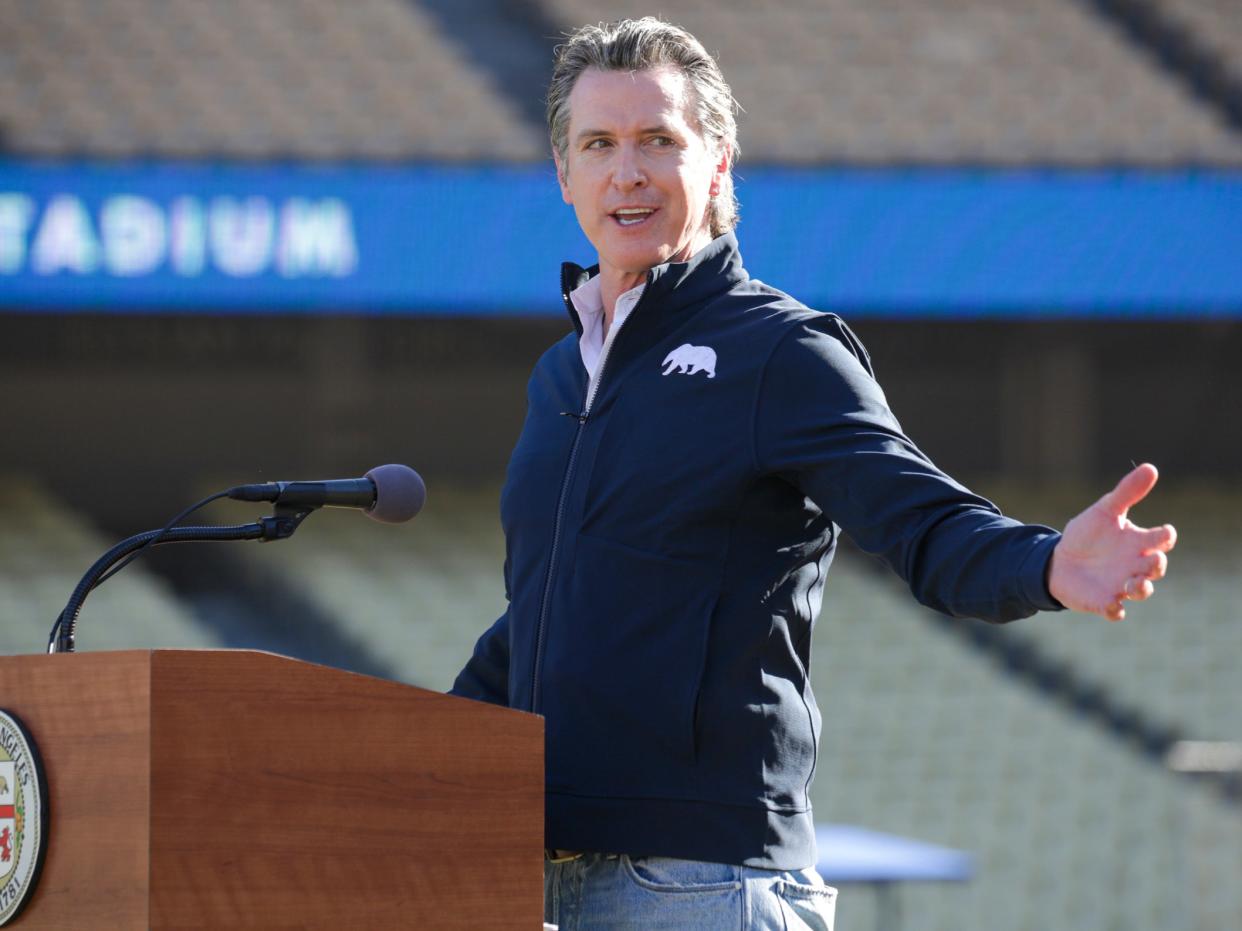 <p> Governor Gavin Newsom addresses a press conference held at the launch of a mass Covid-19 vaccination site at Dodger Stadium in Los Angeles</p> ((Associated Press))