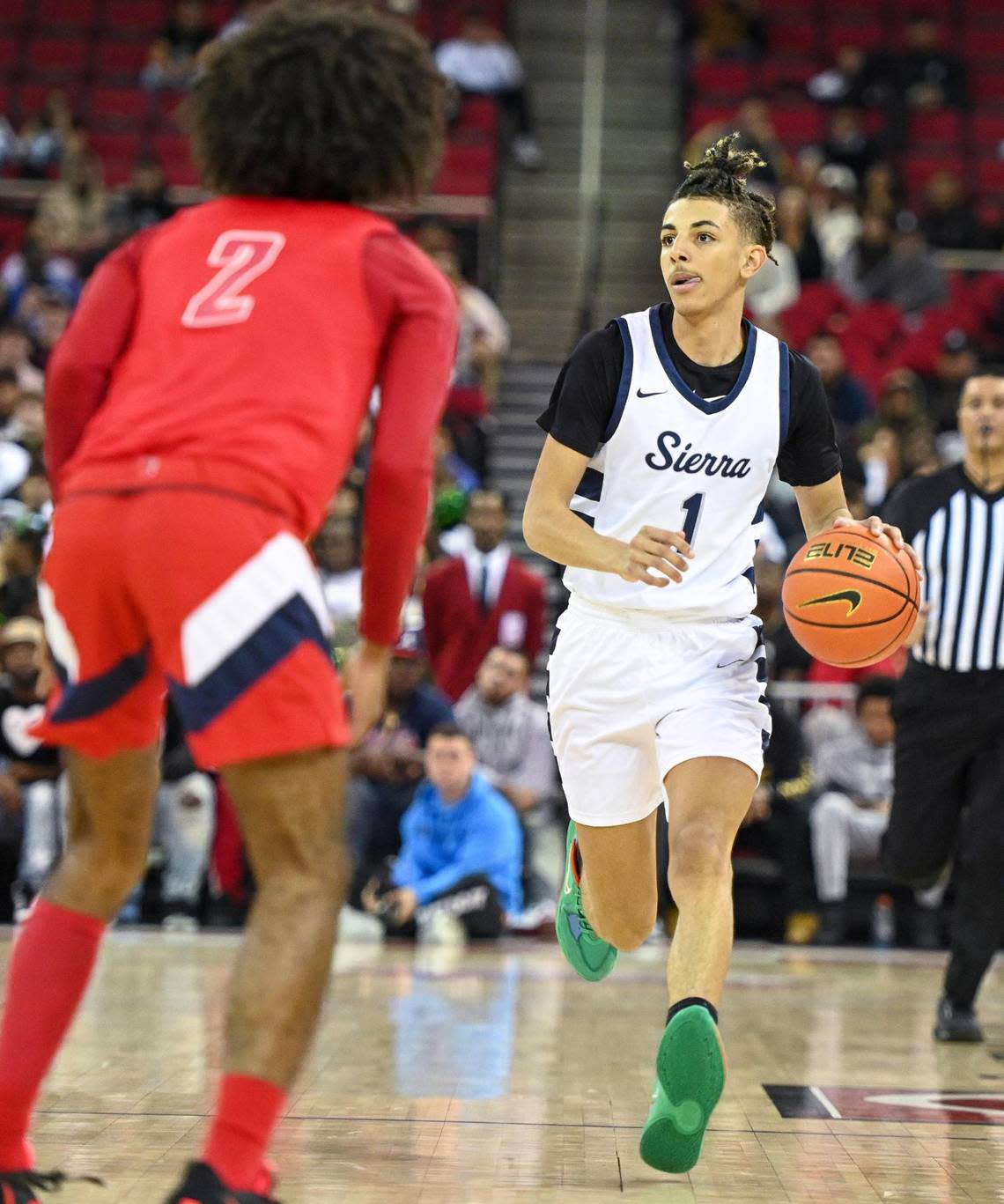 Justin Pippen, right, son of former NBA player Scottie Pippen, of Sierra Canyon, dribbles down court as Memorial’s Abram Potts defends during their game at the Save Mart Center in Fresno on Saturday, Dec. 3, 2022.