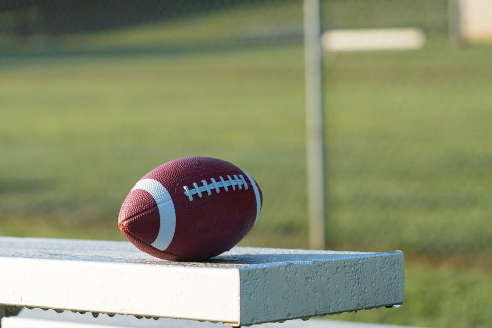 <p>Getty</p> Stock image: Football resting on outdoor bench 