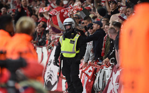 Riot police patrols near Cologne's fans during the UEFA Europa League Group H soccer match between Arsenal FC and FC Cologne at the Emirates Stadium - Credit:  EPA