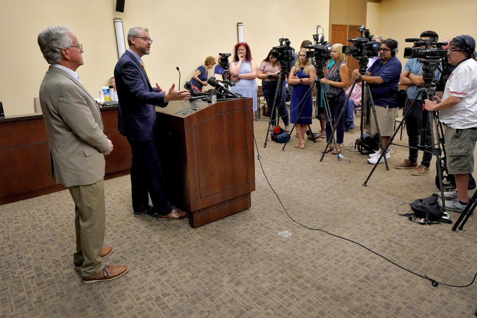 Pinal County Board of Supervisors Chairman Jeffrey McClure, left, listens as Pinal County Attorney Kent Volkmer addresses election day ballot shortages in Pinal county, Wednesday, Aug. 3, 2022, in Florence, Ariz. (AP Photo/Matt York)