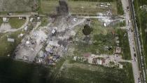 <p>Aerial view of the site of a series of explosions at fireworks warehouses in Tultepec, central Mexico, on July 5, 2018. – At least 17 people were killed, including rescue workers who died saving others’ lives, officials said. The initial explosion occurred around 9:30 am (1430 GMT), then spread to other warehouses just as police and firefighters began attending to the first victims. (Photo: Pedro Pardo/AFP/Getty Images) </p>