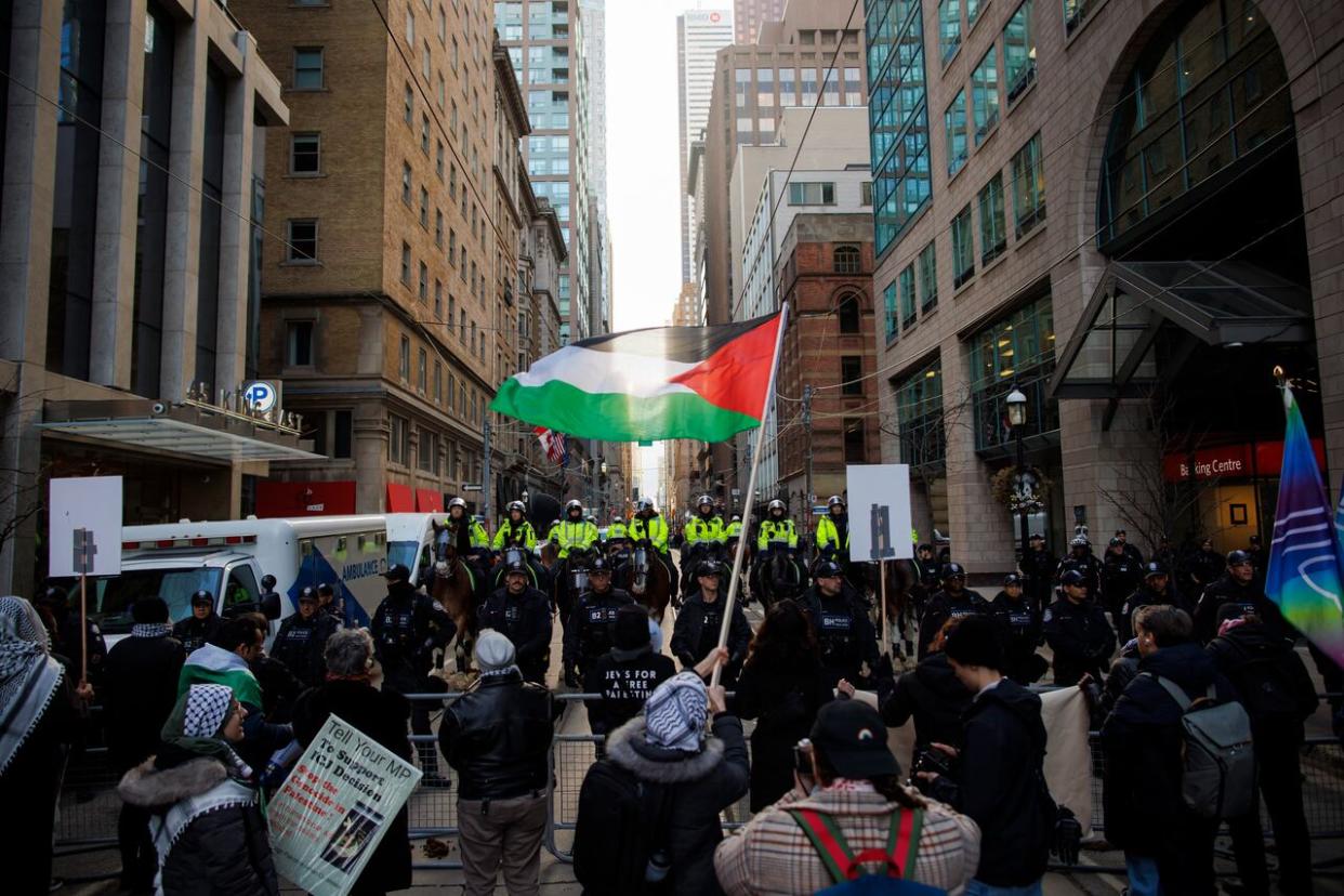 Protesters for Gaza gather outside a downtown hotel in Toronto, the planned location of an event for Prime Minister Justin Trudeau, on Friday, Mar. 15, 2024. (Cole Burston/The Canadian Press - image credit)