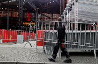 A worker carries a barrier in front of the "Berlinale Palast", where the competition movies will be screened at the upcoming 70th Berlinale International Film Festival in Berlin