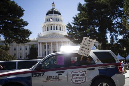 Taxi drivers protest against transportation network companies such as Uber and Lyft along with Assembly Bill 2293 at the State Capitol in Sacramento, California, June 25, 2014. REUTERS/Max Whittaker/File Photo