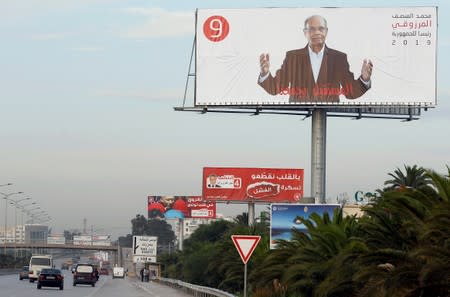 A view shows election campaign billboards of presidential candidates in Tunis
