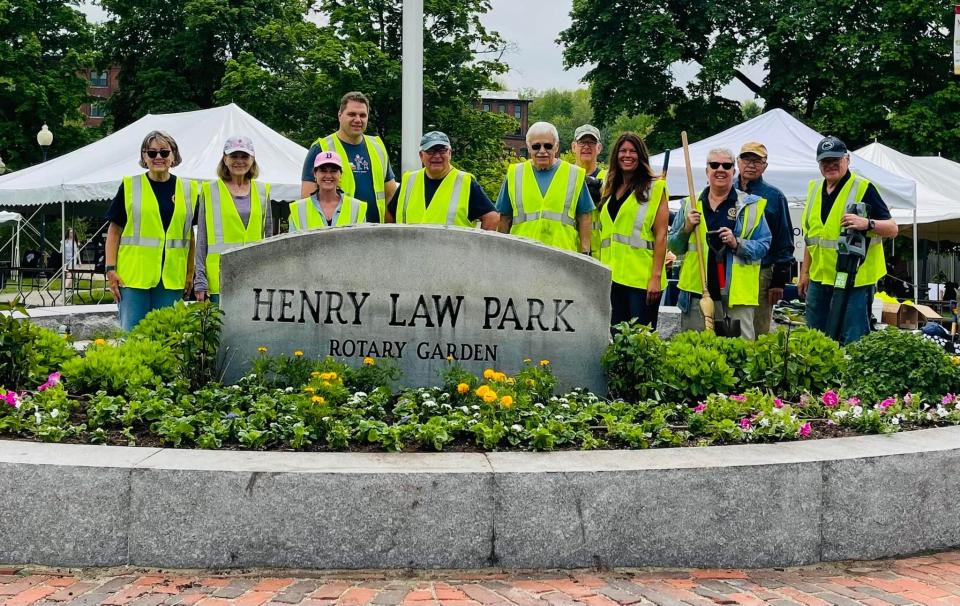 Dover Rotarians seen here planting flowers for the Rotary gardens at Henry Law Park.