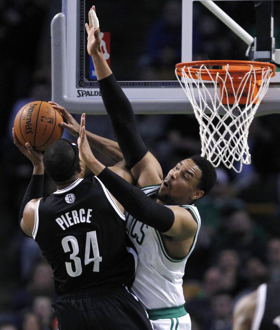 Boston Celtics center Jared Sullinger, right, defends Brooklyn Nets forward Paul Pierce (34) on a drive to the basket during the second quarter of an NBA basketball game, Friday, March 7, 2014, in Boston. (AP Photo/Charles Krupa)