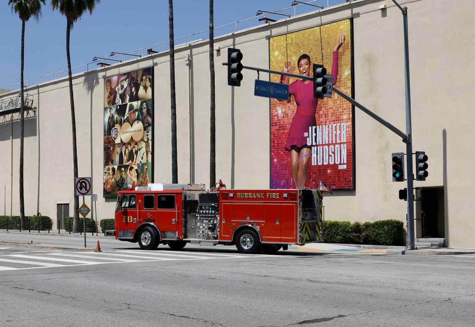 <p>Kevin Winter/Getty </p> Firefighting equipment is seen after a fire is extinguished at Warner Bros.
